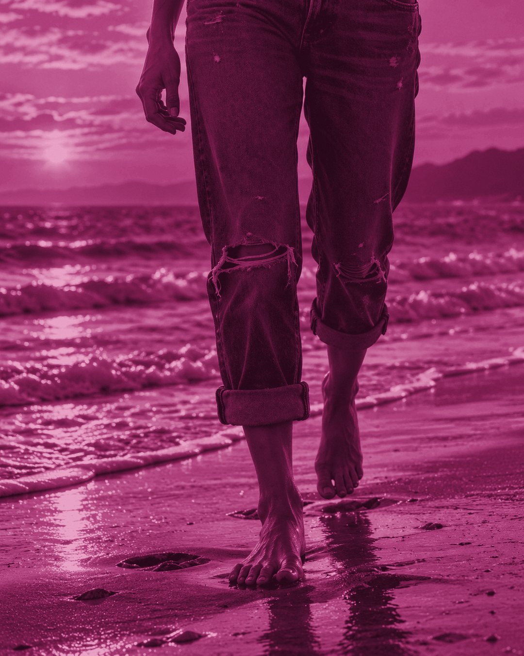 Grace Uncommon walking on a beach beside the water